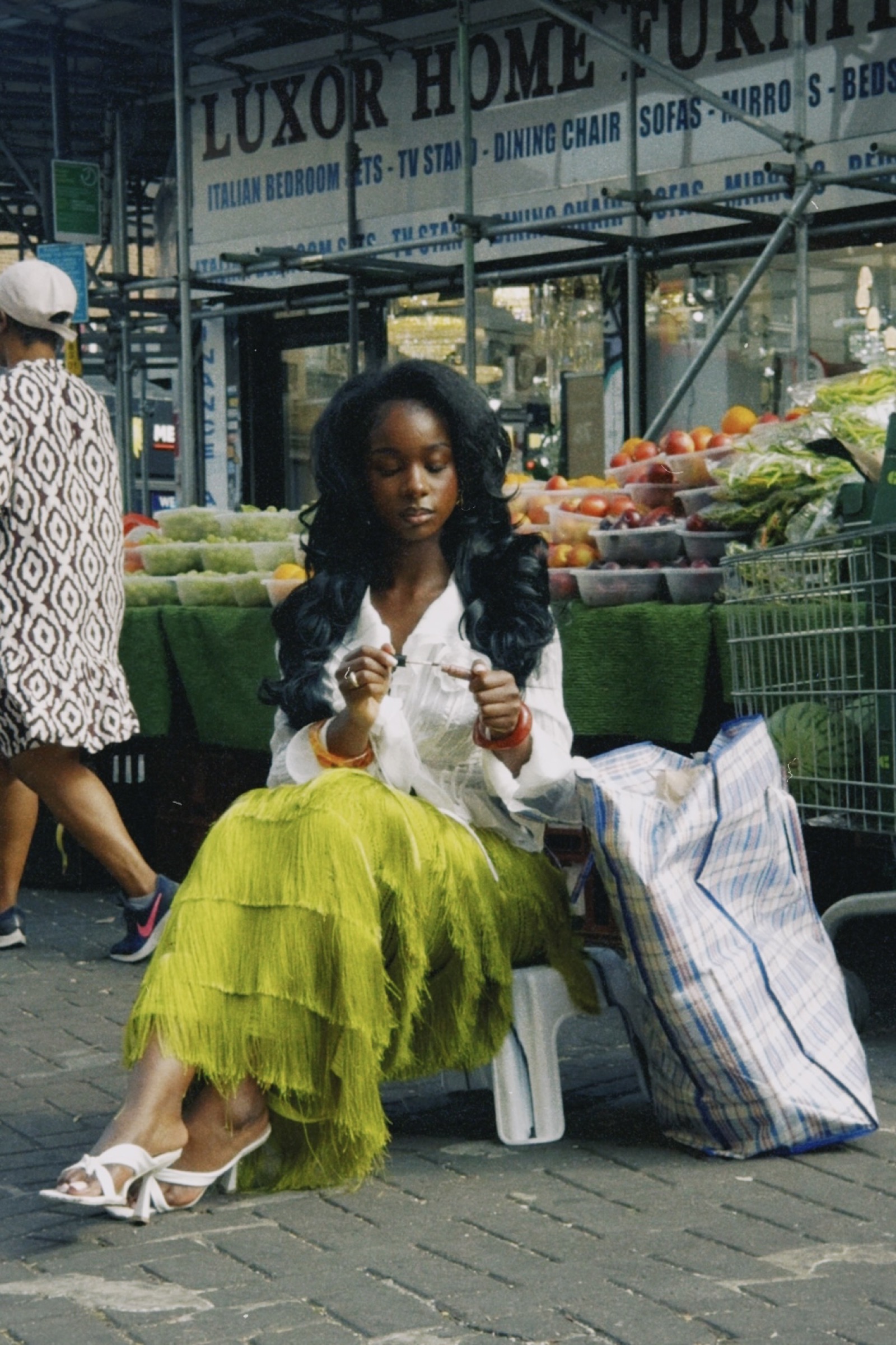 ULLA model sitting outside a fruit market in Peckham